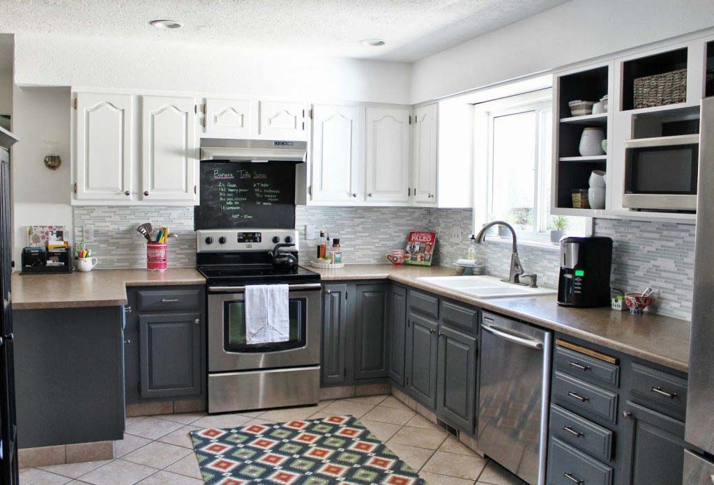A kitchen with grey cabinets and stainless steel appliances