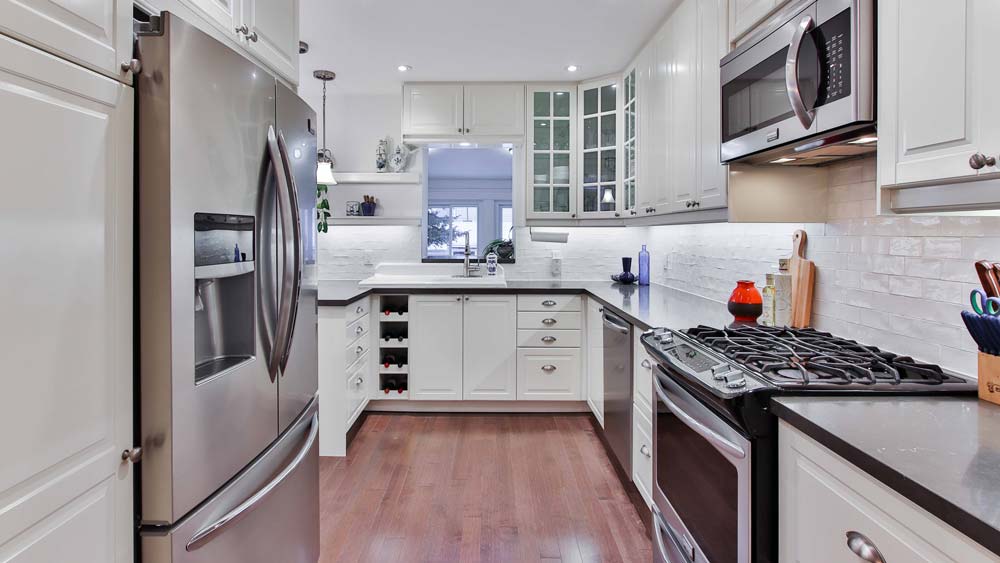 Kitchen with white cabinets and stainless steel appliances